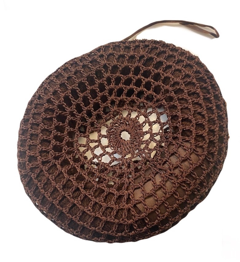 Brown crocheted sun hat featuring a lace-like pattern, showcasing ventilation and style, ideal for warm weather outings.